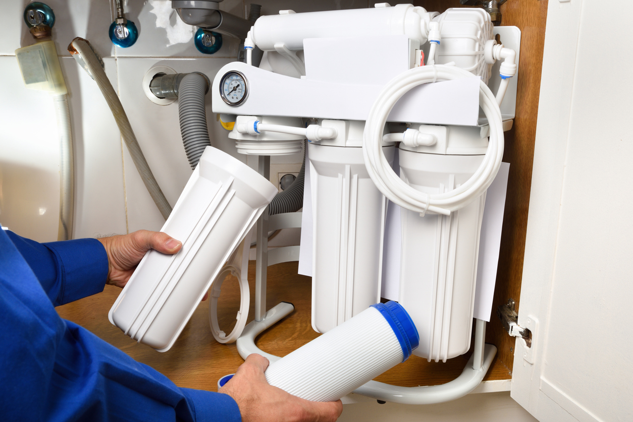 Professional installing a water softener system in a home to combat New Jersey's hard water. 
