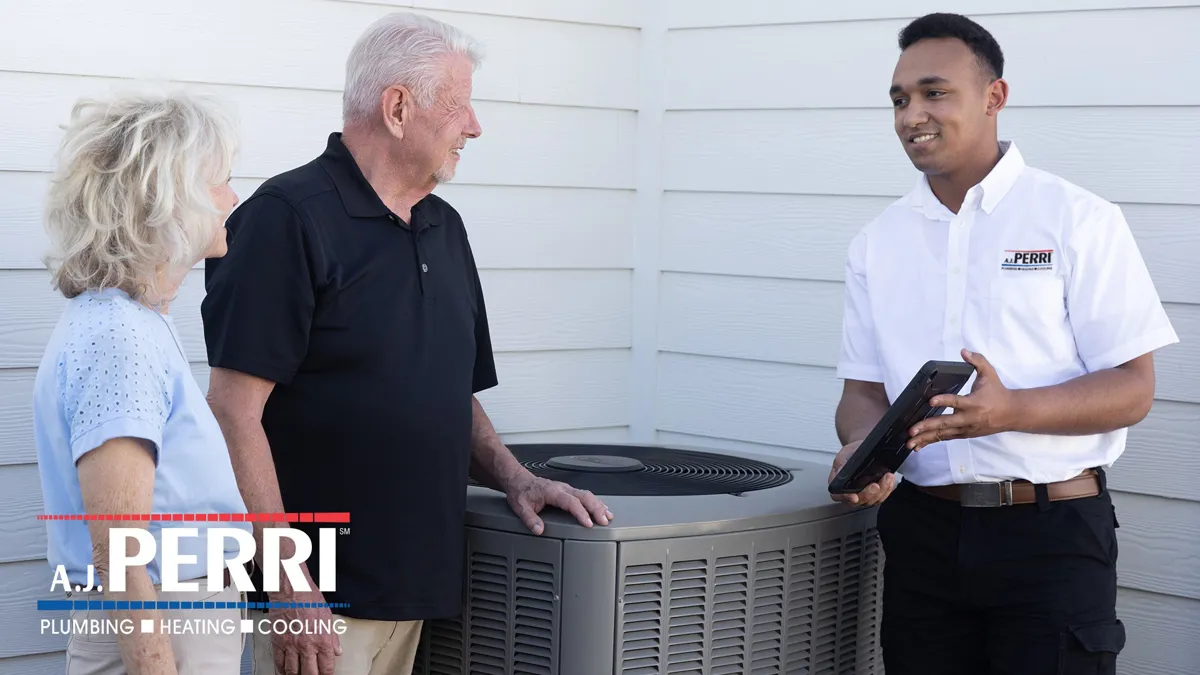 NATE Certified HVAC technician from A.J. Perri speaks to an older couple about their HVAC system at their home in New Jersey.