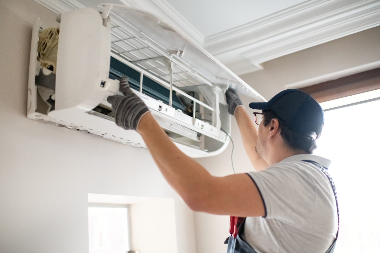 A.J. Perri professionally repairing a ductless air conditioning and heating system at a home in New Jersey.